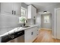 Bright kitchen features stainless steel appliances, marble countertops, and white cabinetry at 2103 S Lafayette St, Denver, CO 80210