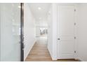 Bright entryway features wood-look flooring and a glass-paneled front door for welcoming natural light at 6636 N Nepal St, Aurora, CO 80019