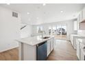 Modern kitchen with stainless steel appliances, a center island, and sliding glass doors to the outside at 6636 N Nepal St, Aurora, CO 80019