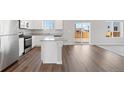 Well-lit kitchen features wood floors, stainless steel appliances, and access to a patio at 7330 Green River Ave, Frederick, CO 80530