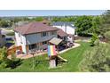 Spacious backyard with a well-maintained lawn, patio area, and a playset at 11513 Greenbriar Ln, Parker, CO 80138