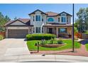 Charming home featuring a manicured lawn with flowering landscape beds and a front porch at 11513 Greenbriar Ln, Parker, CO 80138