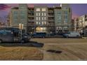 Condo building with a purple sunset and convenient street parking at 275 S Harrison St # 210, Denver, CO 80209