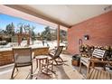 Cozy covered patio with comfortable seating, offering a relaxing outdoor space with views of the snowy landscape at 1333 Mariposa Ave, Boulder, CO 80302