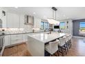 Spacious kitchen with an oversized island, modern appliances, and stylish pendant lighting at 941 Saint Andrews Ln, Louisville, CO 80027