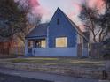 Updated craftsman home with gray exterior, white accents and a landscaped yard at 2824 Cherry St, Denver, CO 80207