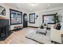 Bright living room with hardwood floors, fireplace and comfortable seating at 2824 Cherry St, Denver, CO 80207