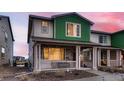 Inviting two-story townhome featuring stone accents and a cozy front porch at 21538 E 59Th Pl, Aurora, CO 80019