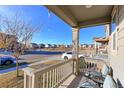 Inviting front porch with comfortable seating and a scenic neighborhood view, perfect for relaxing at 9448 Richfield St, Commerce City, CO 80022