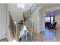 Bright foyer showcasing a staircase with modern railing and light wood floors, leading to the upper level at 9448 Richfield St, Commerce City, CO 80022
