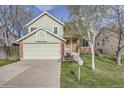 Charming two-story home with a well-maintained lawn, driveway and attached garage at 12036 Monaco Dr, Brighton, CO 80602
