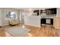 Living room with hardwood floors and kitchen views at 3052 S Grape Way, Denver, CO 80222
