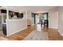Open concept living and kitchen area with hardwood floors at 3052 S Grape Way, Denver, CO 80222