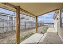 Back patio featuring wooden posts and fenced yard at 130 Elm St, Hudson, CO 80642