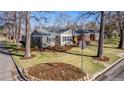 Well-maintained home with mature trees, tidy landscaping, and a neatly manicured front lawn at 860 Magnolia St, Denver, CO 80220