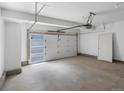 Spacious two-car garage with a door to the house and windows for natural light at 2032 S Holly St # 3, Denver, CO 80222
