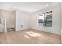 Bright and spacious living room featuring hardwood floors, large window, and modern finishes at 2032 S Holly St # 3, Denver, CO 80222