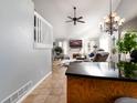 Open living area with vaulted ceiling, fireplace, and large TV at 3200 Masters Pt, Castle Rock, CO 80104