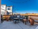 Outdoor patio featuring comfortable lounge seating, a fire pit, and a privacy fence with stylish planters at 11659 W 44Th Ave, Wheat Ridge, CO 80033