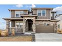 Two-story house with stone accents and a large driveway at 270 Maddox Ln, Erie, CO 80516