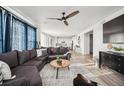 Open-concept living room with a comfortable sofa and access to the modern kitchen area at 270 Maddox Ln, Erie, CO 80516