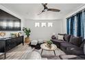 Modern living room featuring a large sectional sofa, stylish decor, and plenty of natural light at 270 Maddox Ln, Erie, CO 80516