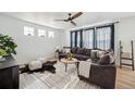 Bright living room featuring stylish decor, a comfortable sofa, and a ceiling fan at 270 Maddox Ln, Erie, CO 80516