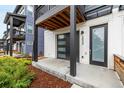 Inviting modern entrance featuring a sleek garage door, and stylish front door at 2052 Alcott Way, Broomfield, CO 80023