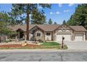 Charming home with a well-manicured lawn and tasteful landscaping, including a mailbox at 1151 Kenosha Dr, Larkspur, CO 80118