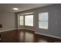 Bright living room featuring hardwood floors, neutral paint and a bay window that provides ample natural light at 20630 E Hamilton Ave, Aurora, CO 80013