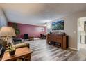 Spacious living room with modern flooring, stylish furniture, and a lovely open connection to the dining area at 7021 S Eudora St, Centennial, CO 80122