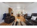 Spacious living room features hardwood floors, a dining area, and comfortable seating at 8403 Chase Dr, Arvada, CO 80003