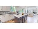 Modern kitchen with an island, stainless appliances and view of living room at 7597 Bison Ct, Littleton, CO 80125