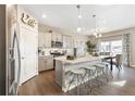 Stylish kitchen featuring a center island, stainless steel appliances, and a cozy dining area at 4202 Sandstone Dr, Mead, CO 80504