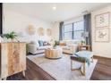 Inviting living room featuring modern decor, neutral colors, and ample natural light at 4202 Sandstone Dr, Mead, CO 80504