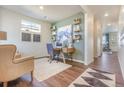 Bright office with a desk and shelves and a comfortable sitting area at 4202 Sandstone Dr, Mead, CO 80504