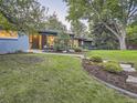 Stunning front exterior showcasing the landscaped yard, stone accents, and stylish front door at 3961 S Clermont St, Cherry Hills Village, CO 80113