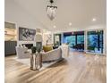 Bright living room with vaulted ceilings, fireplace, and sliding glass doors to the backyard at 3961 S Clermont St, Cherry Hills Village, CO 80113