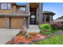 Stately home featuring a grand entryway with a beautiful landscape with an inviting walkway at 34 Amaranth Dr, Littleton, CO 80127
