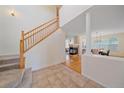 Welcoming foyer with a staircase and views of the living and dining areas featuring a fireplace at 11150 Night Heron Dr, Parker, CO 80134