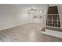 Inviting living area with modern wood flooring, leading to a staircase and adjacent kitchen at 2909 W 81St Ave # E, Westminster, CO 80031