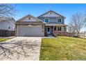 Charming two-story home with stone accents, well-maintained lawn, and attached two-car garage at 551 Rio Rancho Way, Brighton, CO 80601