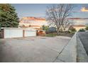 Charming brick home featuring a well-maintained front yard, long driveway and detached two car garage with a new door at 4550 S Fox St, Englewood, CO 80110