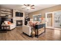 Inviting living room with a stone fireplace, wood floors and neutral decor at 5311 S Danube Ct, Centennial, CO 80015