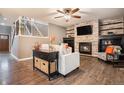 Inviting living room with fireplace, wood floors, and staircase at 5311 S Danube Ct, Centennial, CO 80015