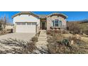 Charming one story home with stone accents, landscaped front yard, and a two car garage at 16494 Aliante Dr, Broomfield, CO 80023