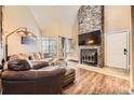 Cozy living room with a stone fireplace, wood floors, and a comfortable couch at 814 S Vance St # F, Lakewood, CO 80226