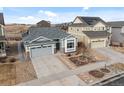 Aerial view of a single Gathering home with a gray roof, a two car garage, and manicured front yard at 15271 Grasslands Dr, Parker, CO 80134