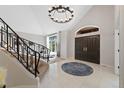 Elegant foyer with tile flooring, a grand staircase, and a decorative chandelier at 9 Mule Deer Trl, Littleton, CO 80127