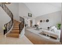 Open living room with a view, adjacent to a curved staircase at 9 Mule Deer Trl, Littleton, CO 80127